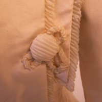 Detail View of White Jacket with Cinched Waist