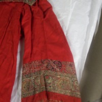 Detail View of Red Fringed Coat with Paisley Trim