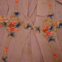 Detail View of Blue-Gray Dress with Embroidered Flowers