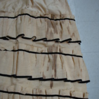 Detail View of Cream Bodice and Skirt with Black Trim